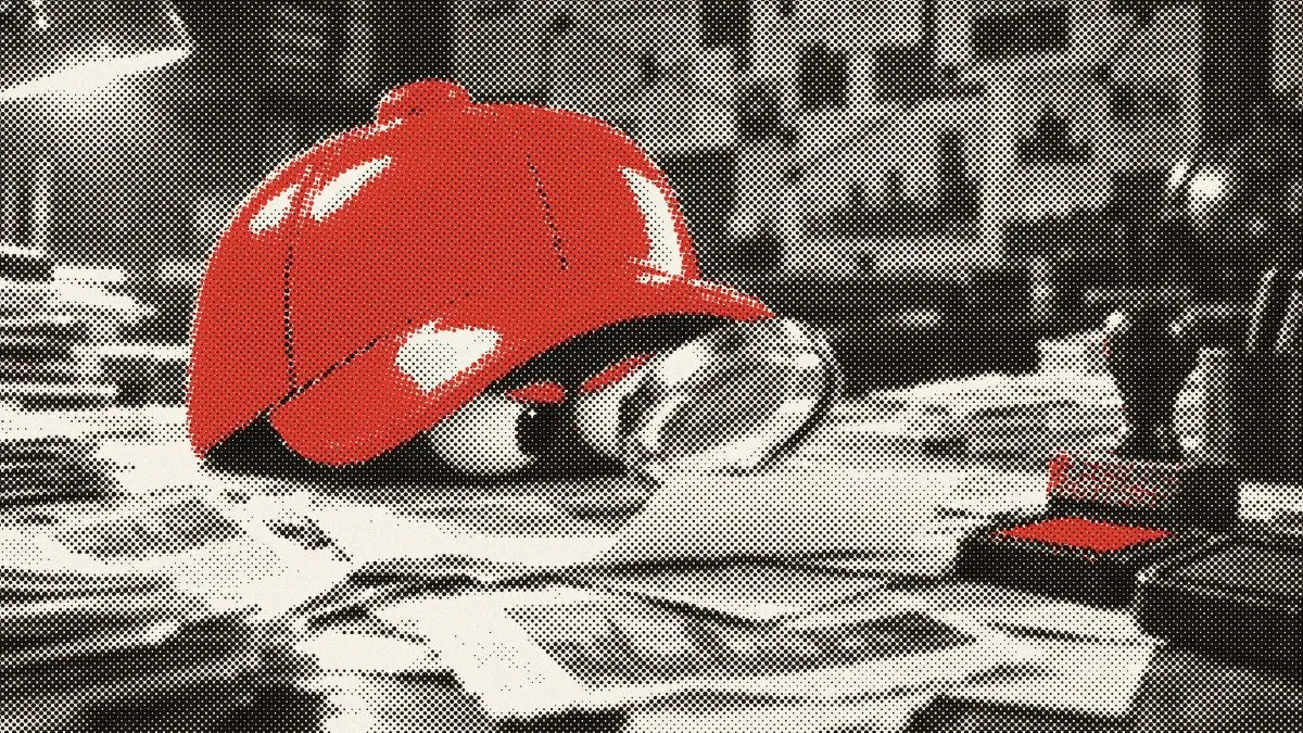 The desk's red cap peers at a clipping through a magnifying glass